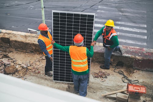 Solar Technicians Holding Solar Panel