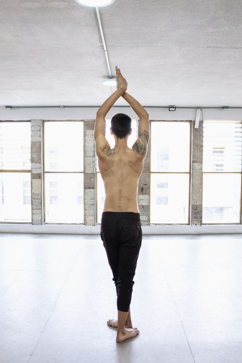 Free Shirtless male ballet dancer rehearsing poses in a bright dance studio. Stock Photo
