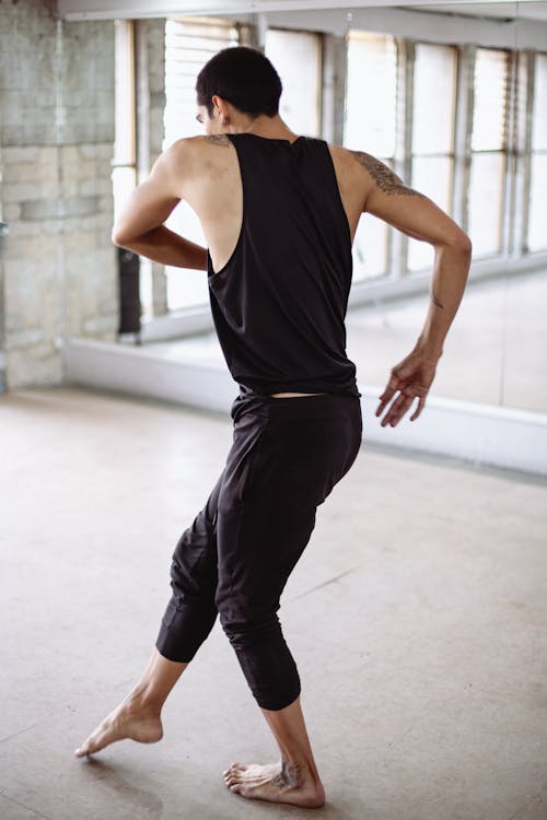 Man in Black Tank Top and Pants Dancing 