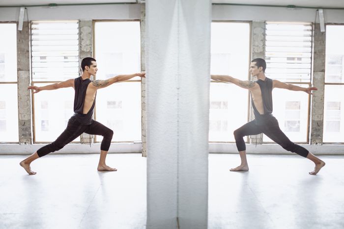 Male dancer rehearsing in front of studio mirrors