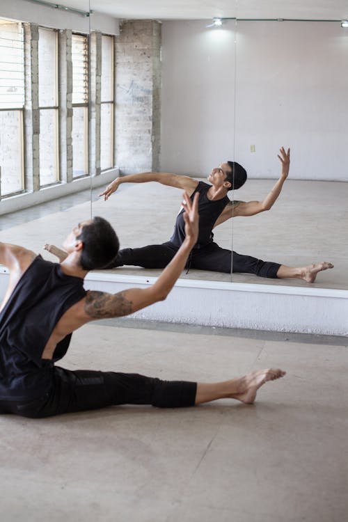 A Ballet Dancer Rehearsing in Front of a Mirror