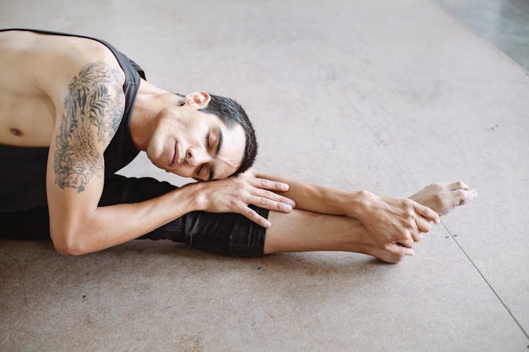 Woman In Black And Grey Tank Top Lying On Floor