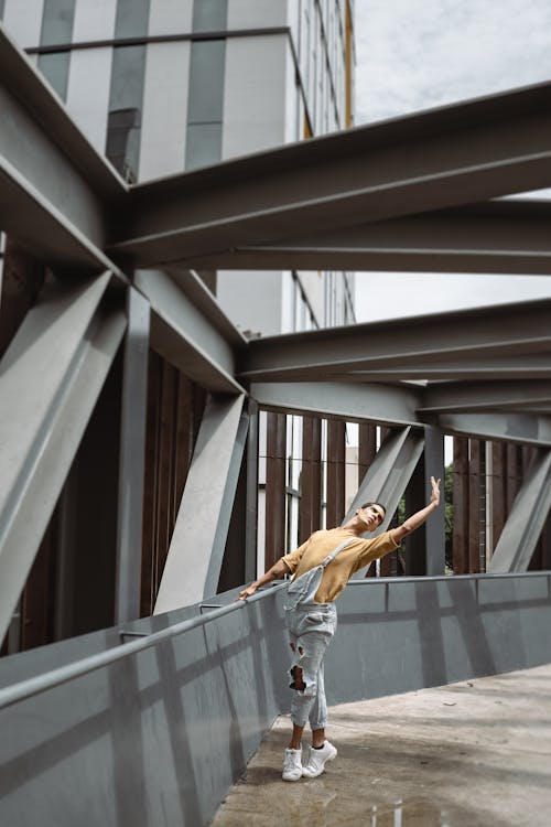 Man Dancing Beside Concrete Railing