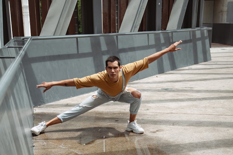 A Man Dancing Ballet Over A Bridge