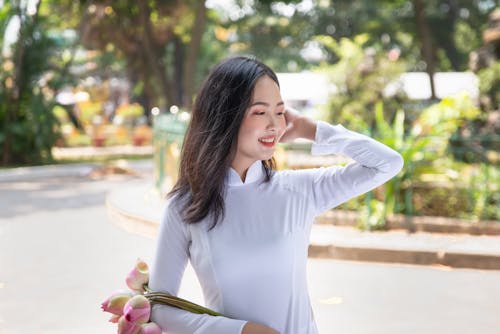 Free Woman in White Dress Fixing her Hair  Stock Photo