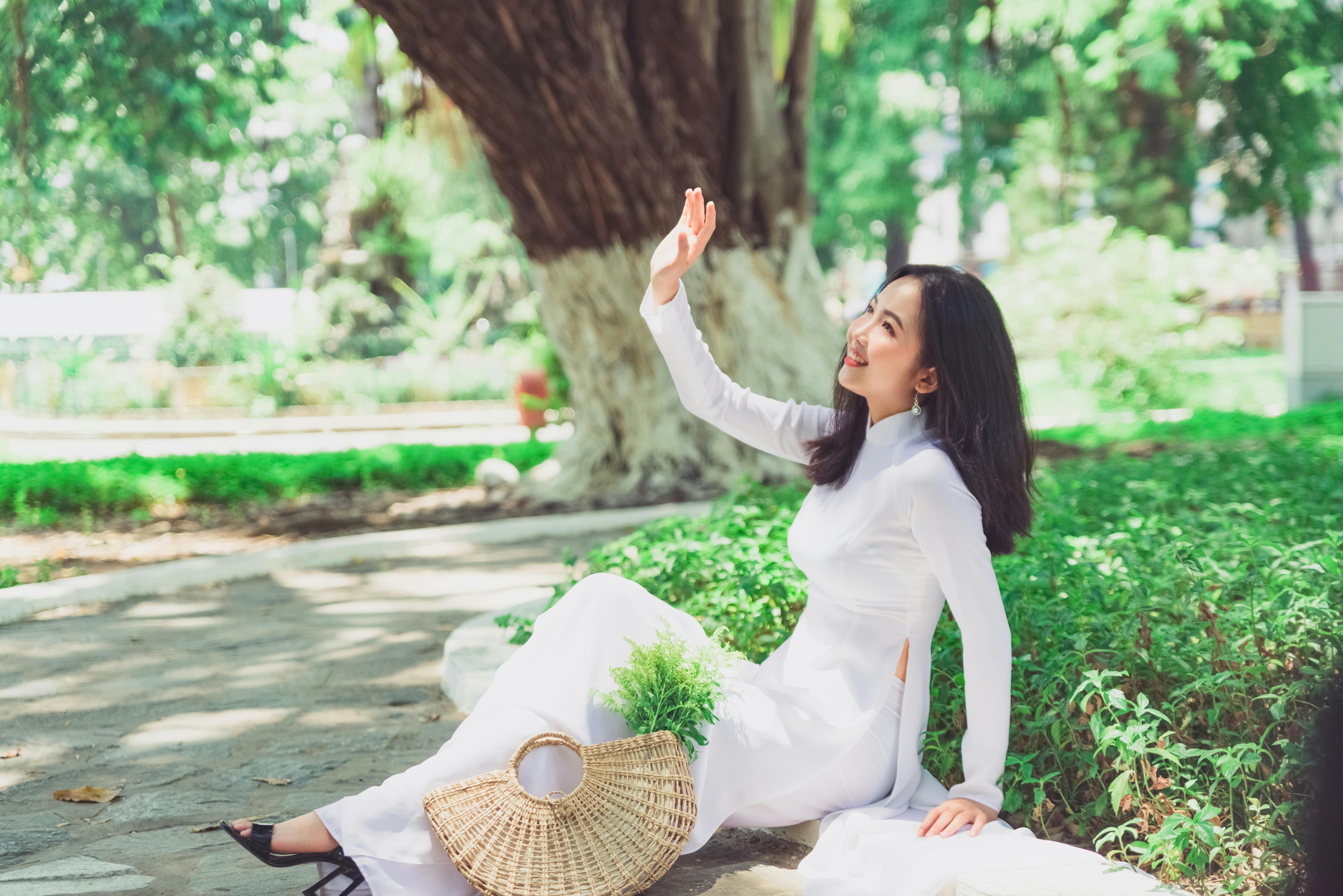 Woman in White Clothes Sitting in the Park 