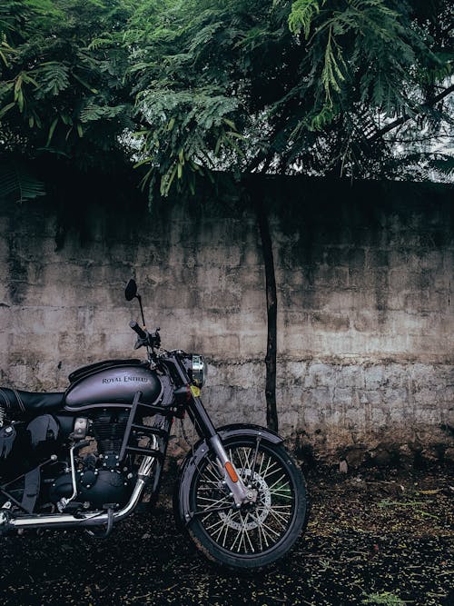 Black Motorcycle Parked Beside Wall