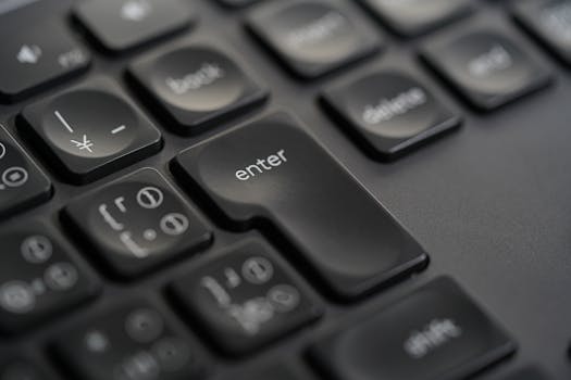 Detailed close-up photograph of a black keyboard's enter key, showing precision and modern design.
