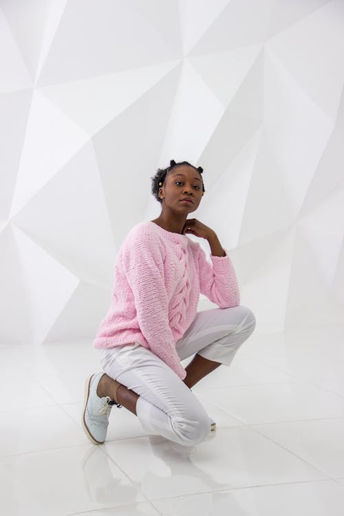 Free Woman Wearing Pink Sweater and White Pants Posing Stock Photo