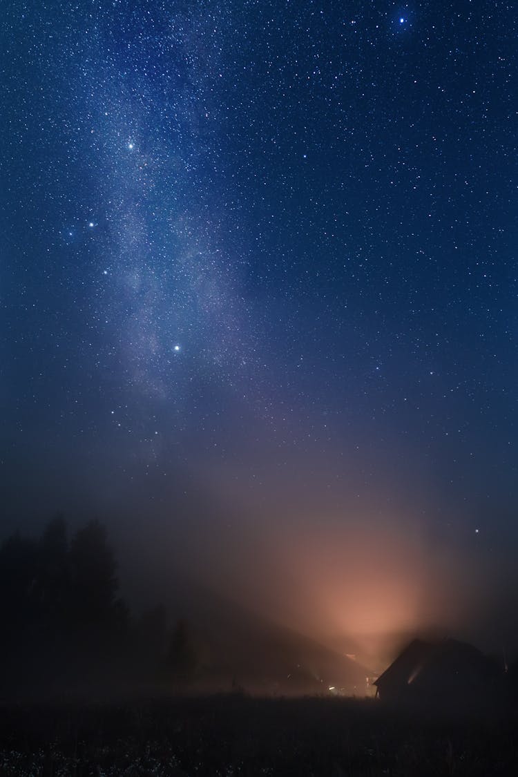 Starry Night Sky Above House In Fog