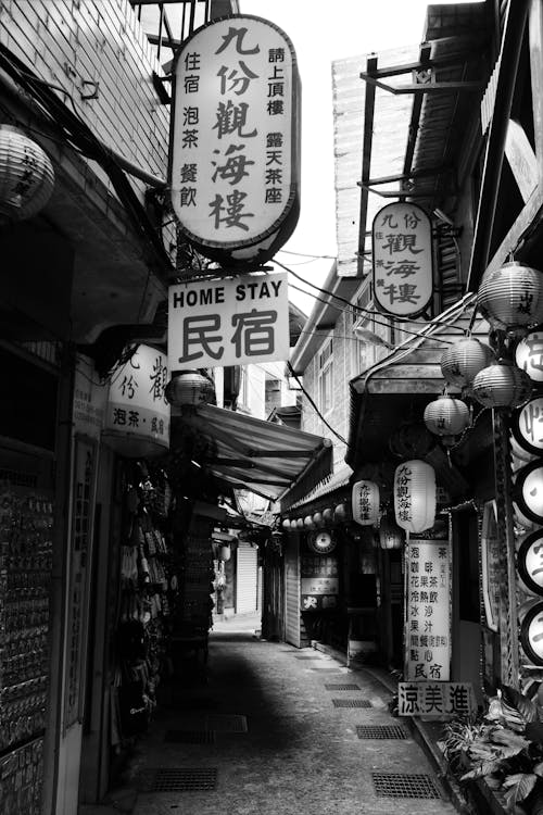 Grayscale Photo of a Street with Signages