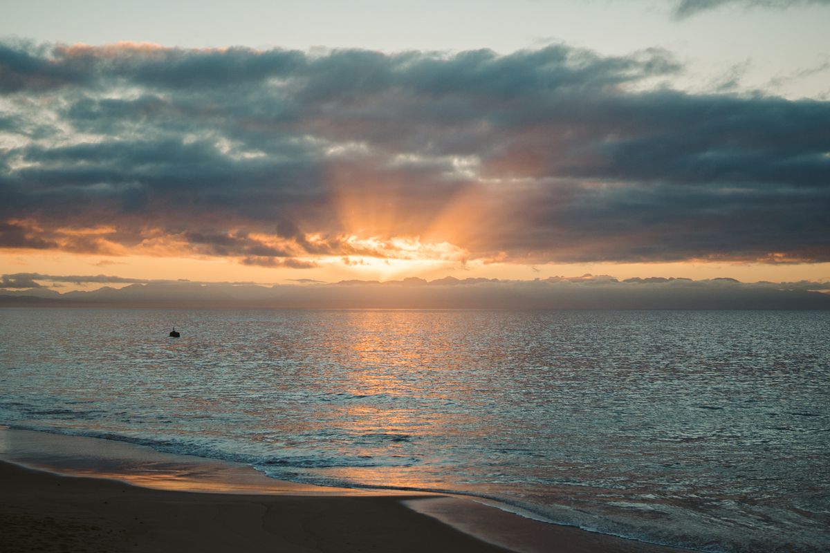 First light breaking over a calm shoreline
