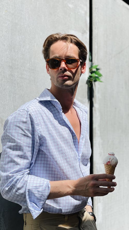 Man Wearing Sunglasses Holding an Ice Cream