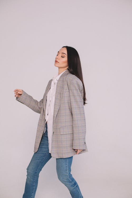 Free A Woman in Plaid Long Sleeves and Denim Pants Stock Photo