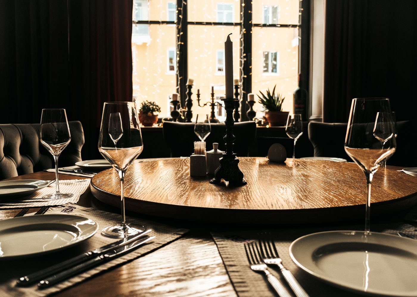 A beautifully set dining table with a candlelit ambiance, perfect for elegant gatherings.