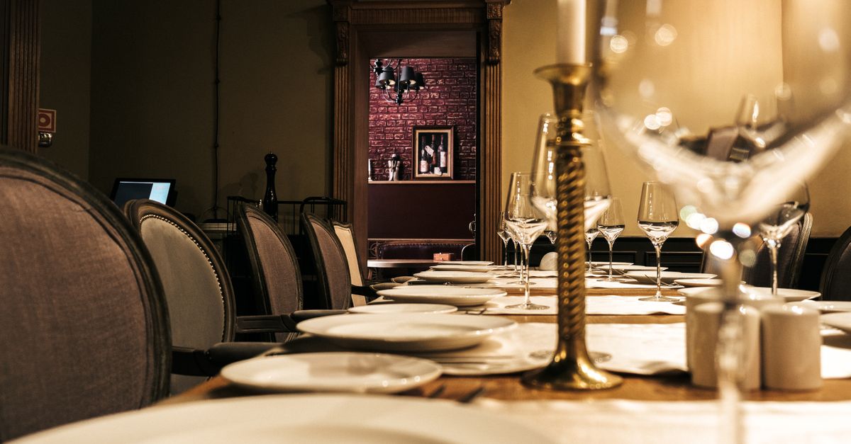 A sophisticated dining setup with candles and wine glasses, ready for an intimate restaurant experience.