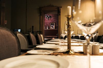 Candlelit dining room laid for service — photo by Alexandra Kollstrem on Pexels