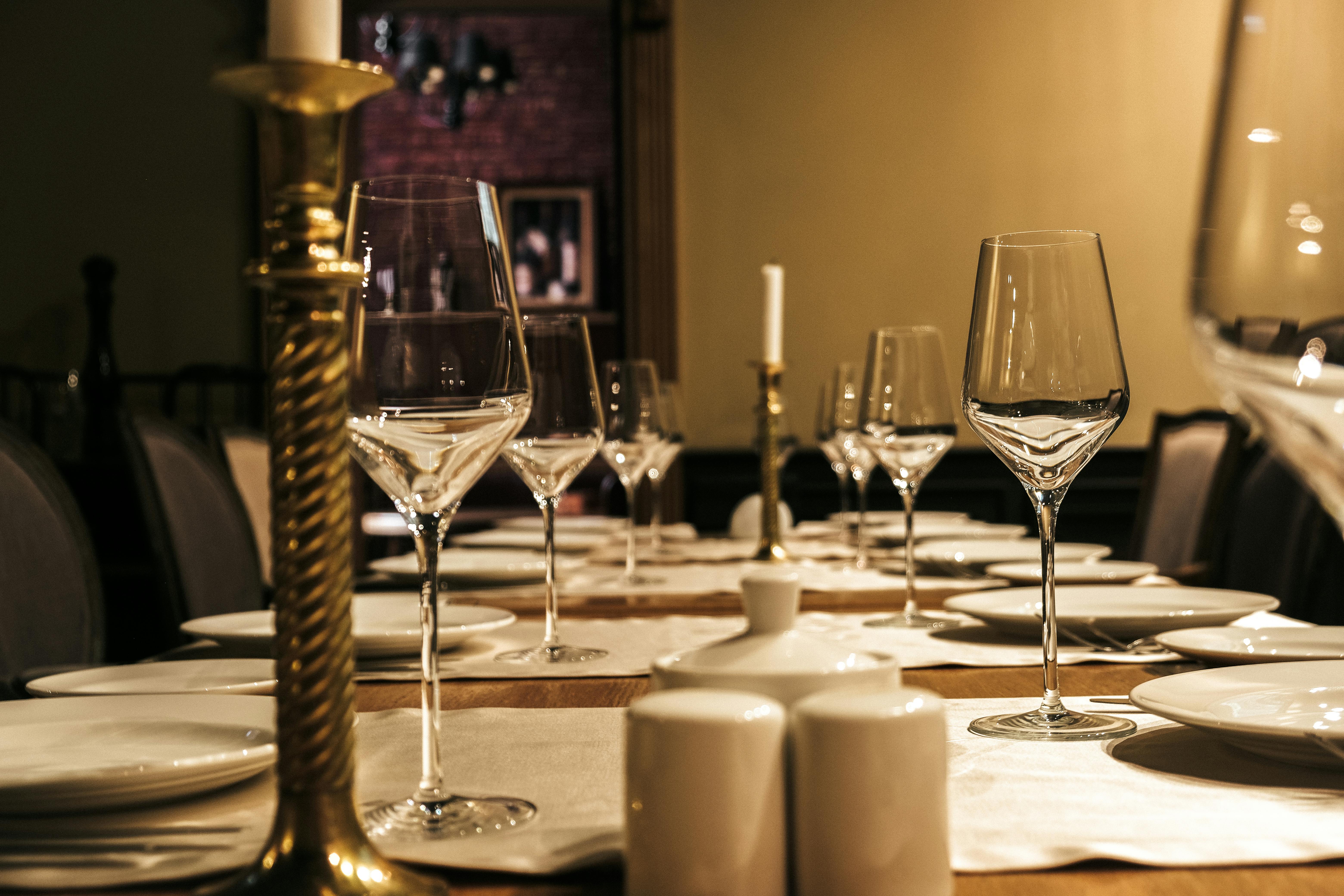 personalised napkin holder - Luxurious table setup with wine glasses and candle holders in an elegant dining setting.