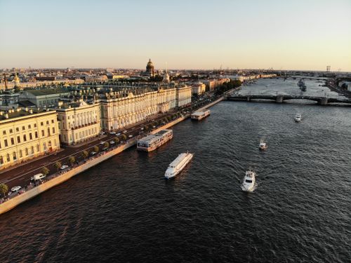 Free Stunning aerial view of St. Petersburg's Neva River waterfront with iconic landmarks at sunset. Stock Photo