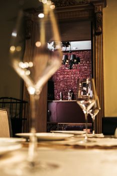 Cozy dining setup featuring elegant wine glasses and stylish decor, ideal for a sophisticated dining experience.