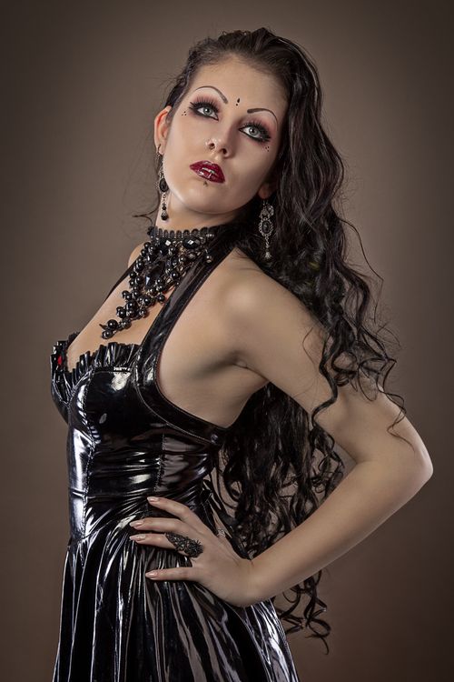 Free Striking portrait of a woman in black latex dress, exuding elegance and fashion-forward style. Stock Photo