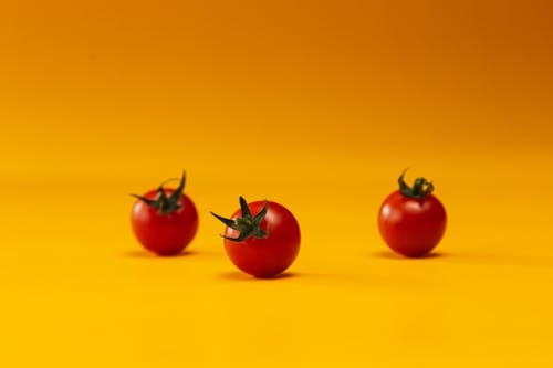 Photo of Cherry Tomatoes on a Yellow Surface