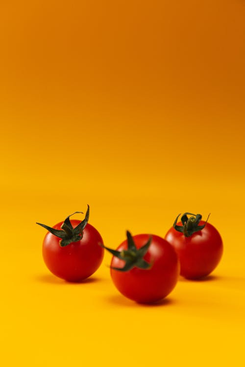 Red Tomatoes on Yellow Surface