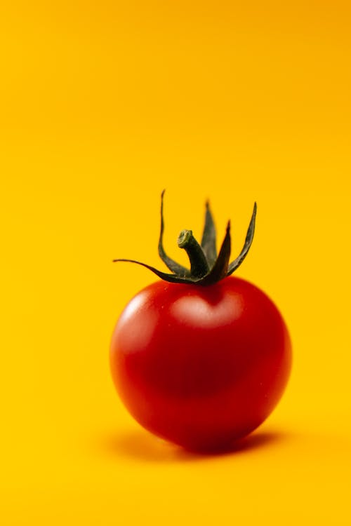 Red Tomato on Yellow Background