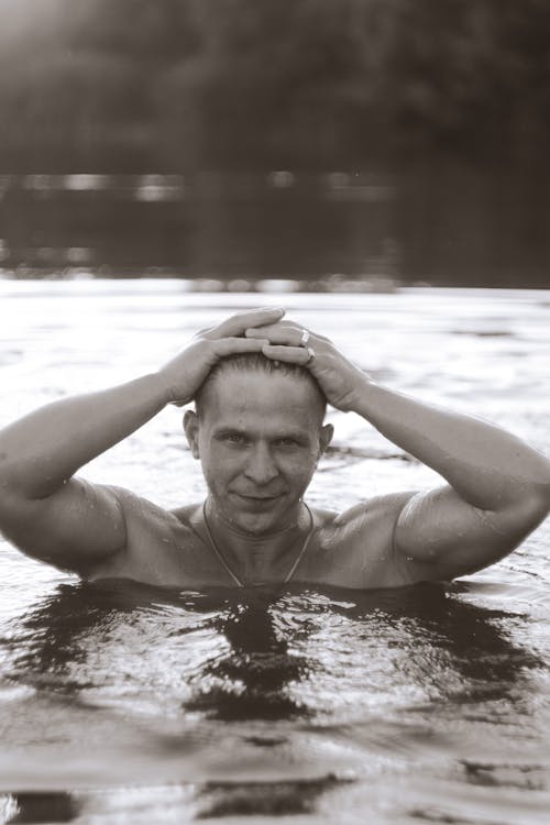 Free Black and White Photo of a Man in Water Stock Photo