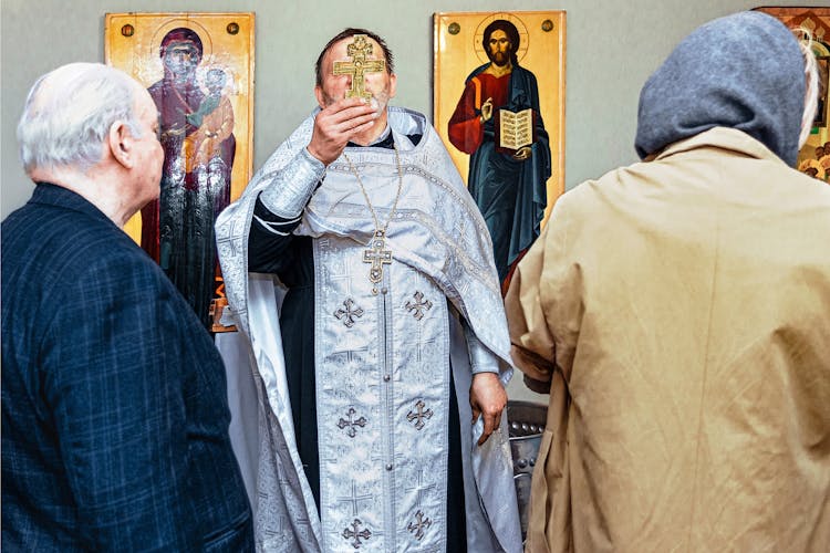 Priest Holding A Crucifix