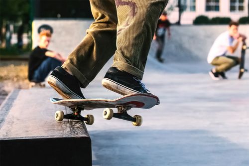 Free Dynamic shot capturing the movement of a skateboard trick at a skatepark. Stock Photo
