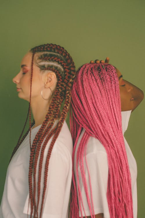 Woman with Braided Hair Standing Back to Back 