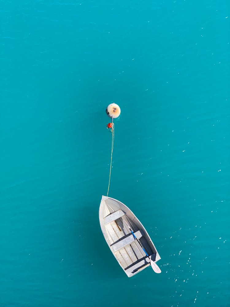 Wooden Boat Tied To A Buoy On A Lake