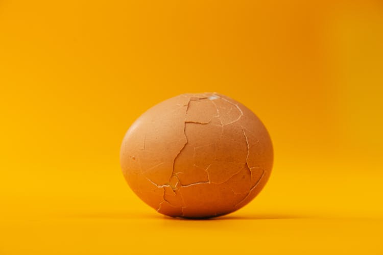 Cracked Egg Shell On Yellow Background