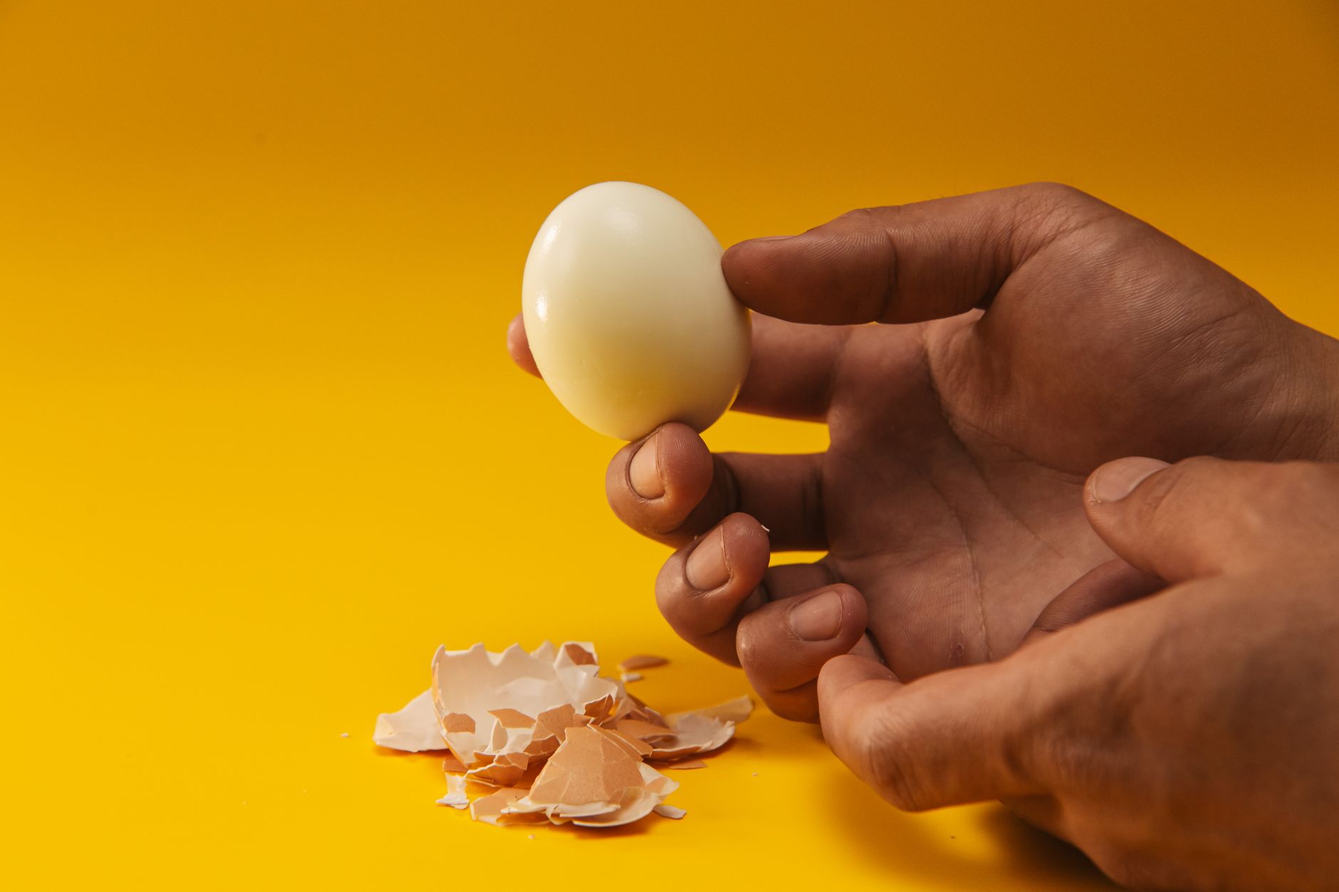 Hard boiled eggs in a bowl with some cracked shells