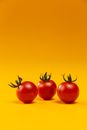 3 Red Tomatoes on Yellow Surface