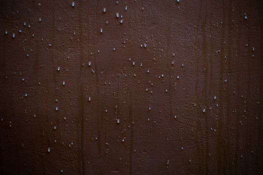 Water droplets on a brown masonry wall — chimney water infiltration and leak sources