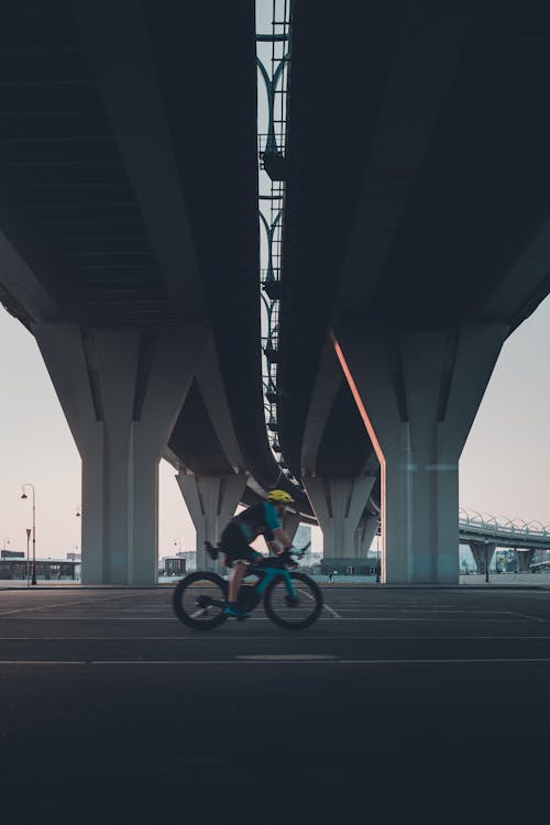 Person Riding a Blue Bicycle on a Highway