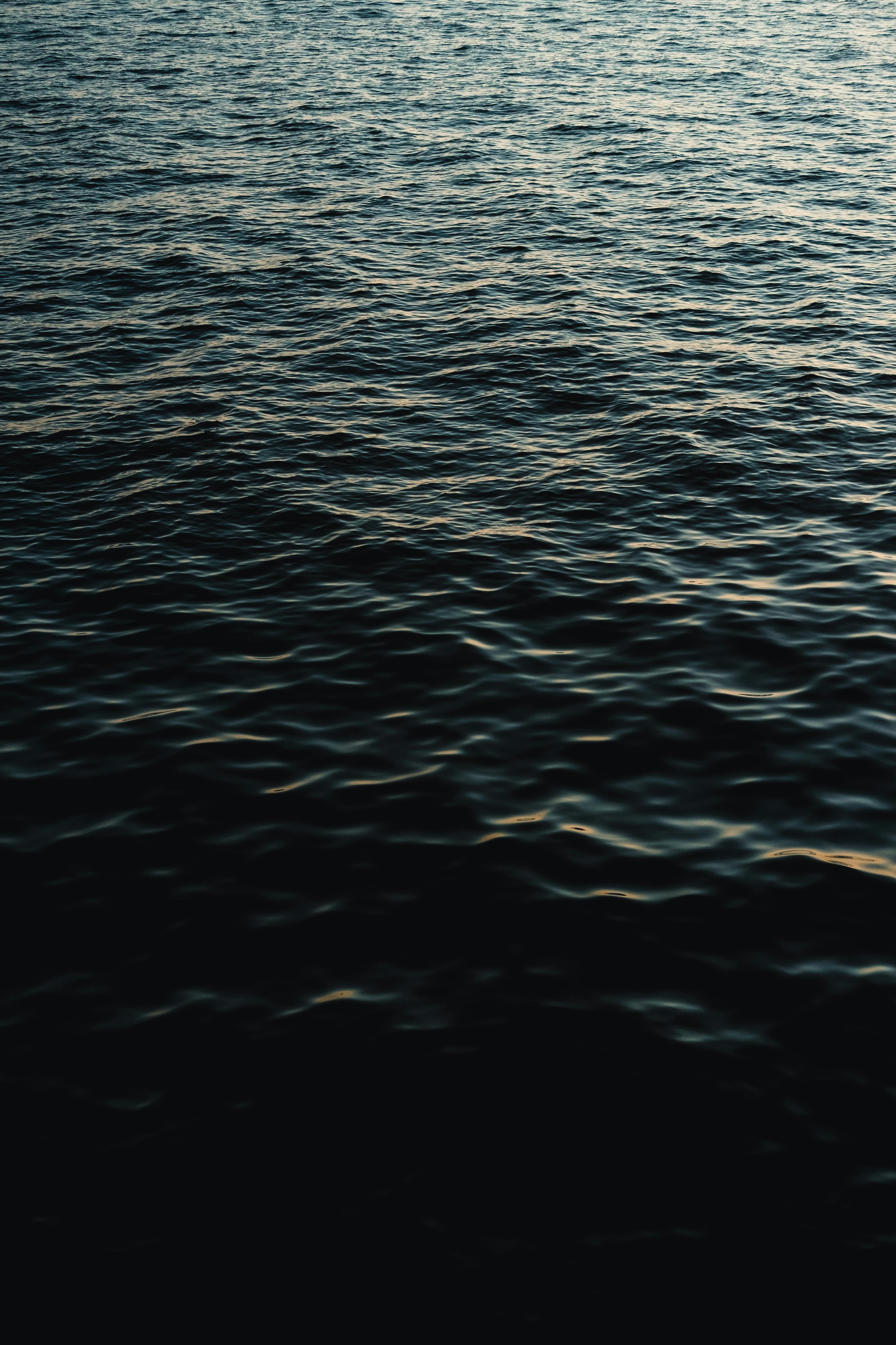 Captivating ripples on the ocean surface with a serene sunset glow in Saint Petersburg, Russia.