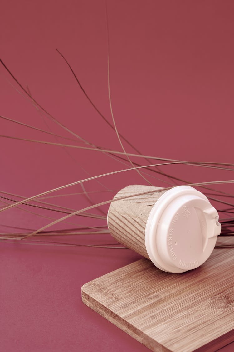 A Corrugated To-Go Coffee Cup On A Wooden Board