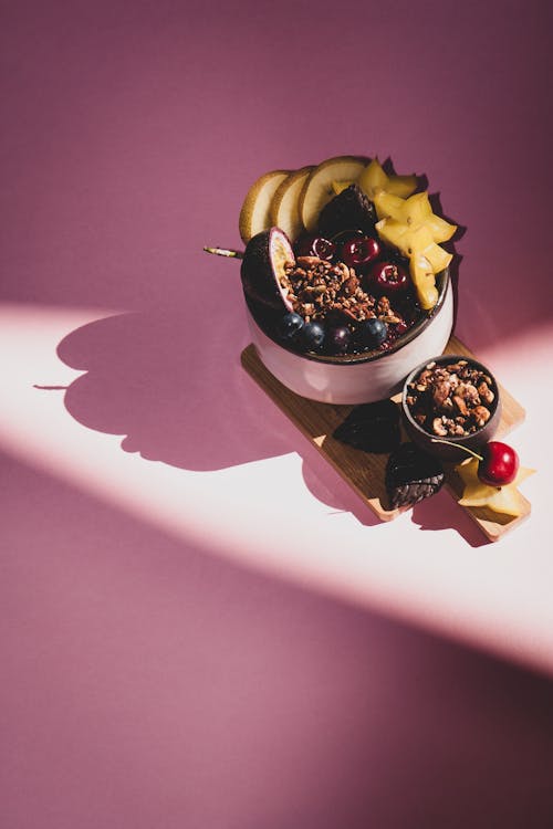 Bowls on Top of Chopping Board on a Pink Surface 