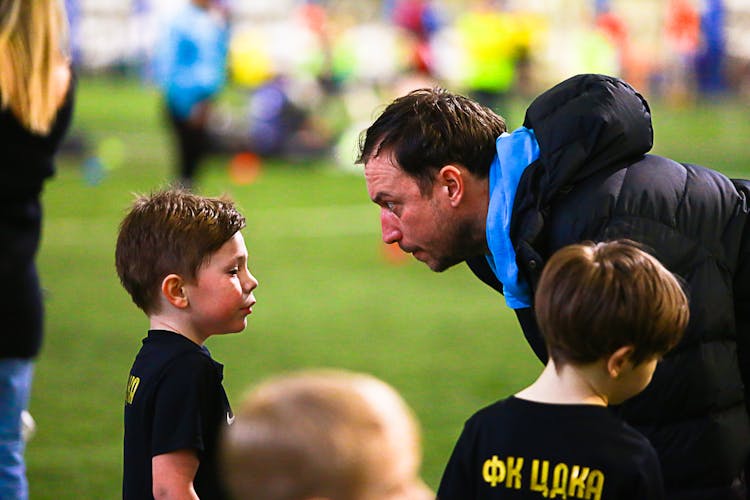 Couch Talking To A Boy During A Football Game