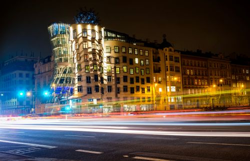 Free Stunning night photograph of Prague's Dancing House with light streaks, showcasing architectural brilliance. Stock Photo