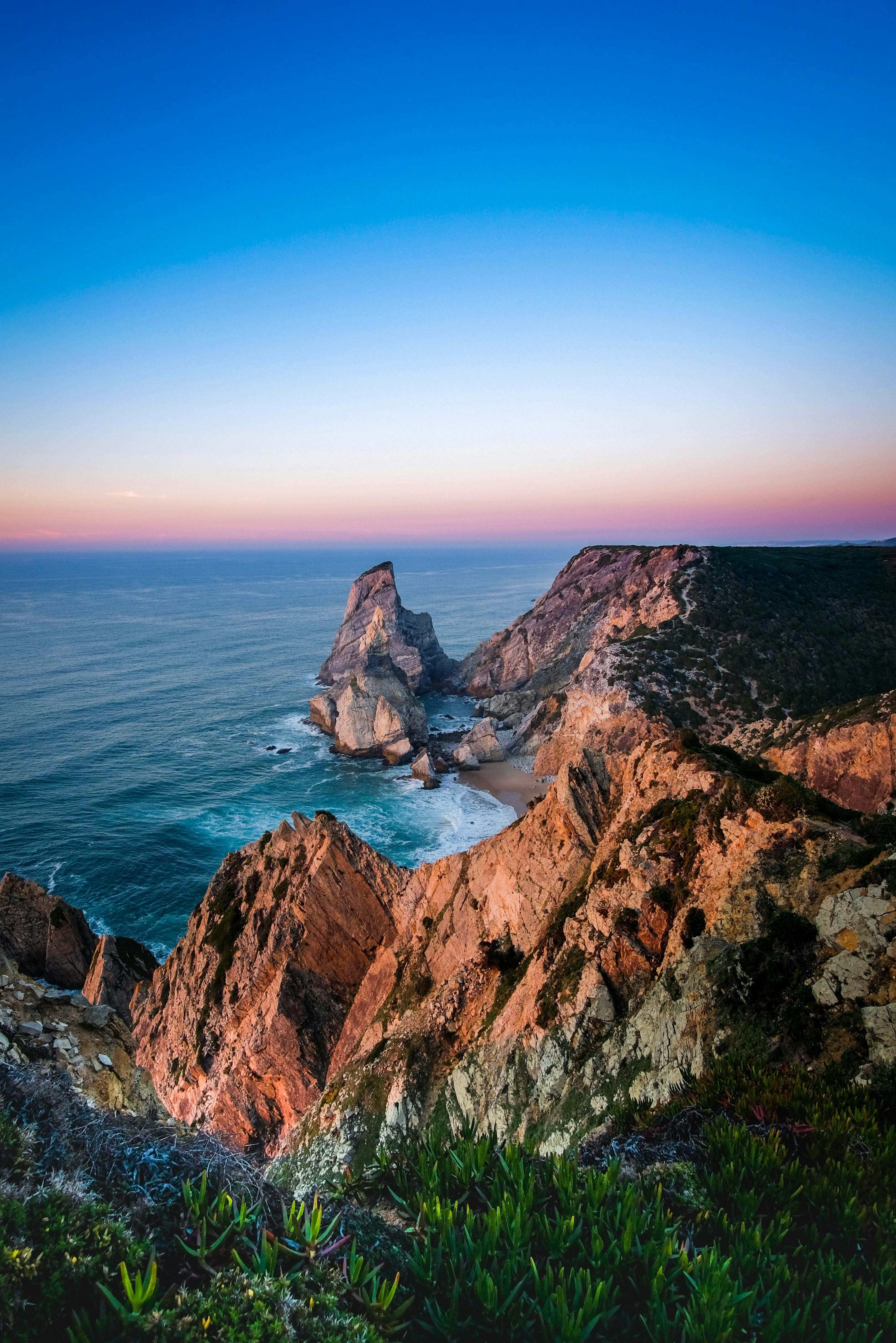 pink sunset above cliffs and ocean