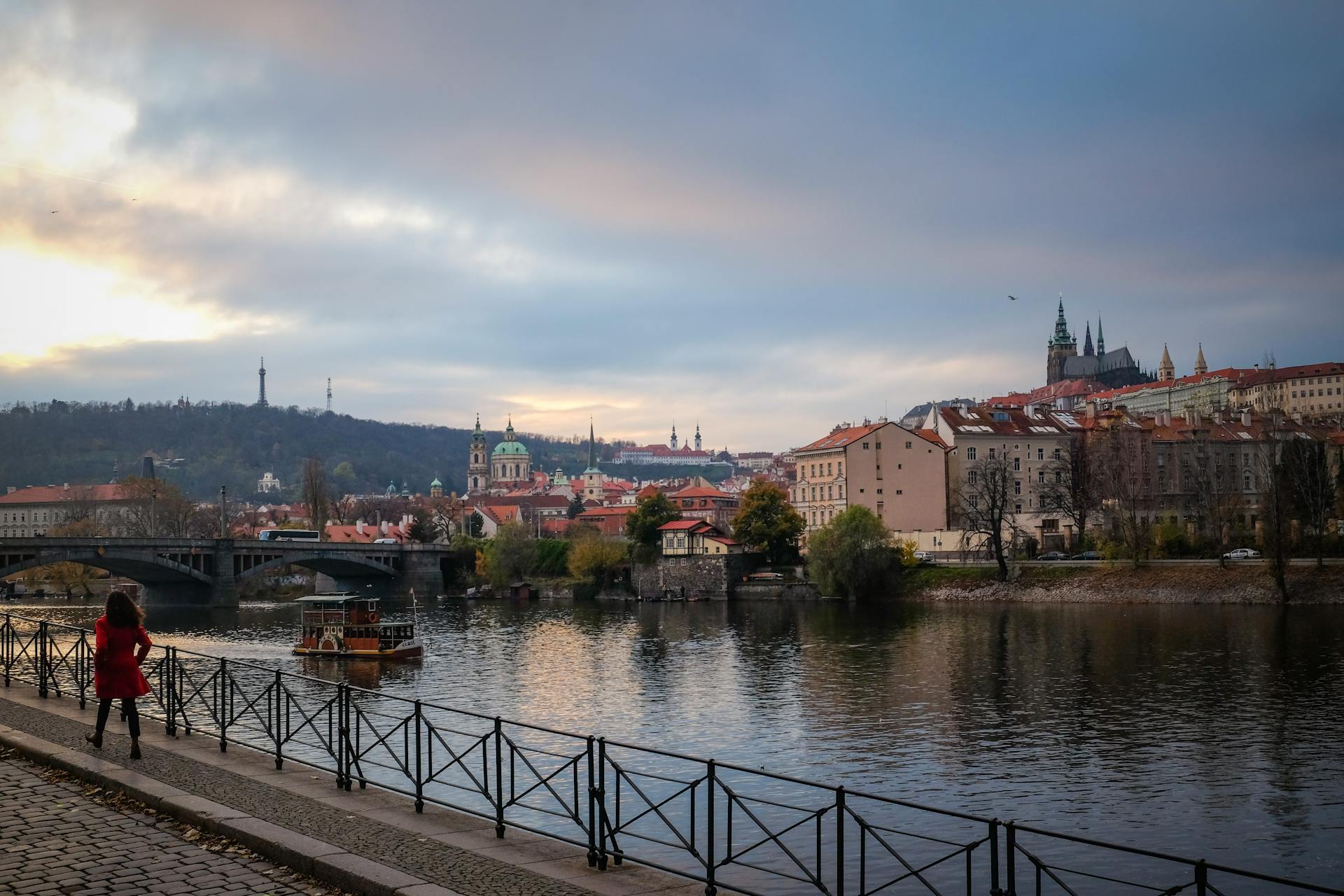 Stunning view of Prague's cityscape featuring Charles Bridge and Prague Castle during a serene twilight moment.