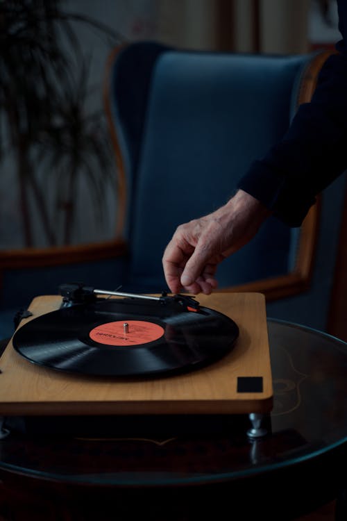 Free Person using a Wooden Phonograph Player  Stock Photo