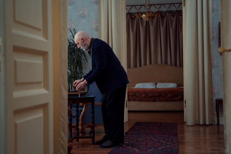 A Old Man Playing Music With A Turntable