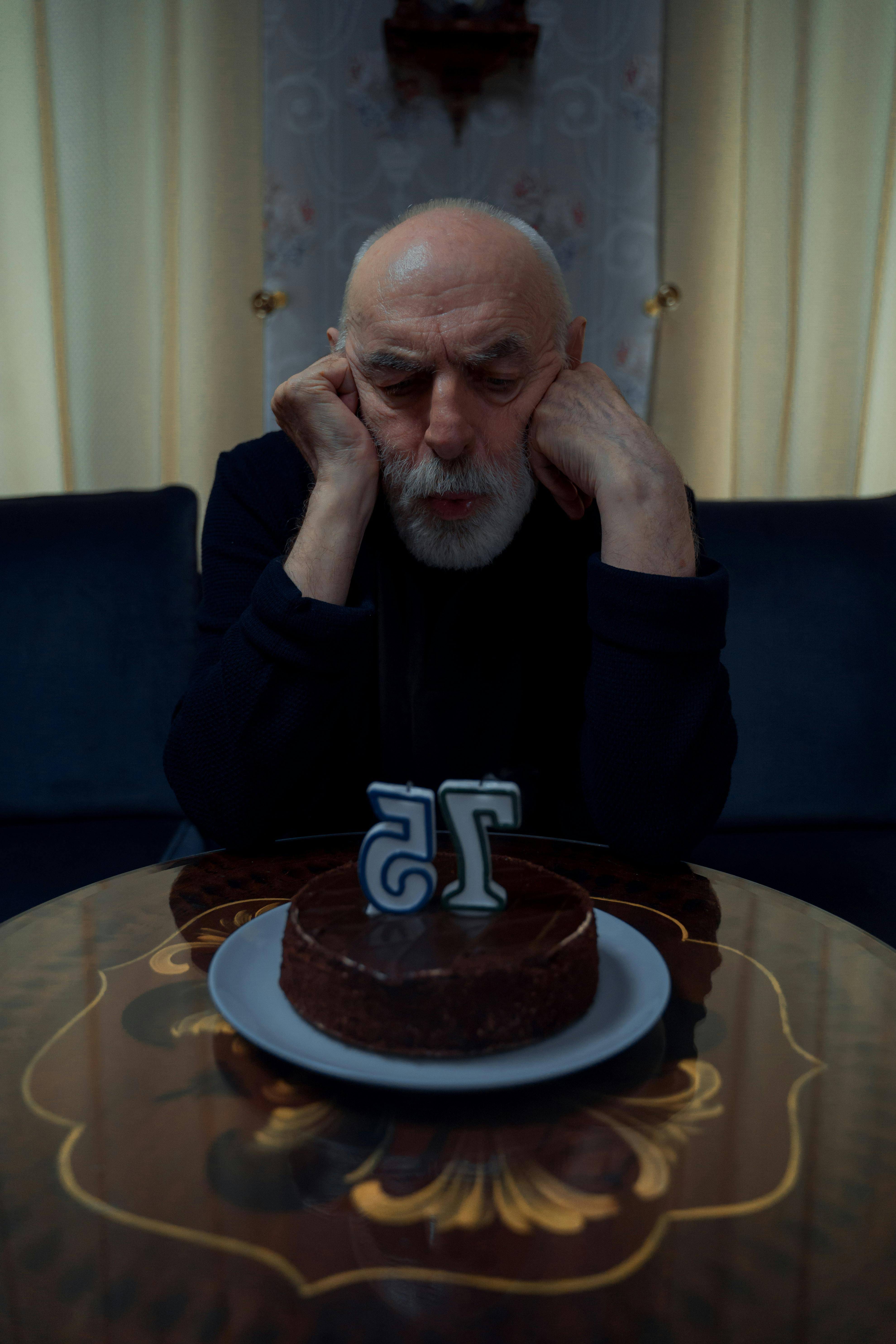 man looking at his birthday cake