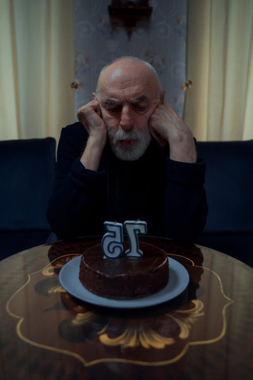 Man Looking at his Birthday Cake