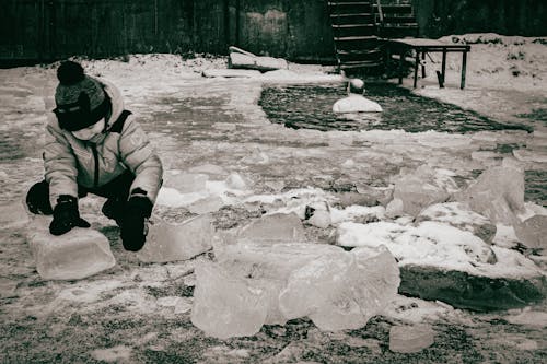 Photo of a Kid Playing with Ice